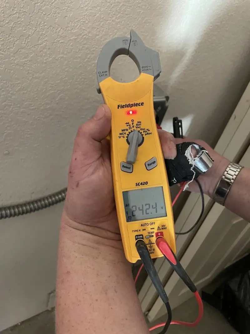 Voltage testing with clamp meter during Ceiling Fan Installation in Camden
